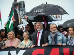 Julian Assange makes rare public appearance at Gaza protest march in Sydney