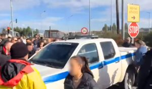 Greek farmers clash with police: Angry protesters lift patrol car and smash windshield with crowbar