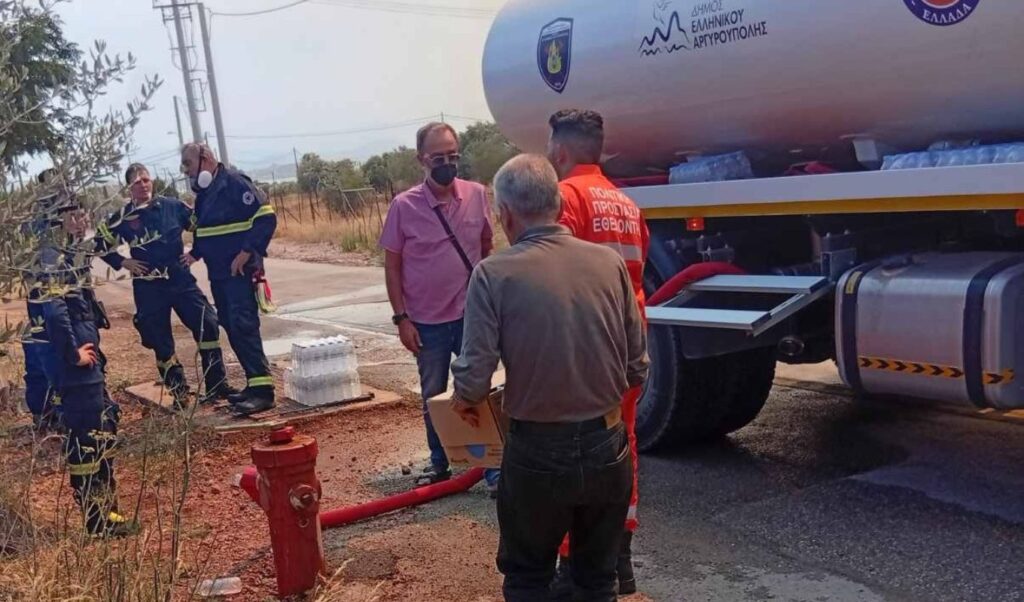 SYRIZA visits fire-hit West Attica, delivers 1,500 water bottles to firefighters